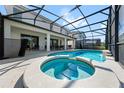 Enjoy this screened-in pool and spa, perfect for relaxation and outdoor entertaining at 438 Marcello Blvd, Kissimmee, FL 34746