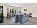 Comfortable living room with modern furnishings, hardwood floors, sliding glass doors to the outside, and tasteful decor at 4542 Cypress Cay Way, Kissimmee, FL 34746