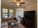 Inviting living room area with large windows, neutral furnishings, and an adjacent dining area at 501 Mirasol Cir # 203, Celebration, FL 34747
