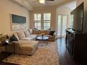 Relaxing living room featuring a plush sectional sofa, large windows, and stylish decor at 501 Mirasol Cir # 203, Celebration, FL 34747