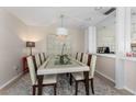Bright dining room with a modern chandelier, elegant table setting, and stylish decor at 5053 Maui Cir # 14, Orlando, FL 32808