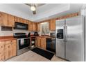 Efficient kitchen features wood cabinetry, stainless steel appliances, and a functional layout at 5053 Maui Cir # 14, Orlando, FL 32808