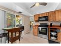 Cozy kitchen with wood cabinets and stainless appliances, connects seamlessly to the outdoor patio at 5053 Maui Cir # 14, Orlando, FL 32808