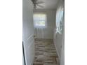 Cozy bedroom featuring charming plank flooring, white walls and ample natural light from the windows at 5562 Old Tampa Hwy, Davenport, FL 33896