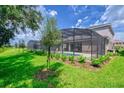 Spacious backyard featuring a screened-in pool area, perfect for outdoor relaxation and entertainment at 6086 Broad Oak Dr, Davenport, FL 33837