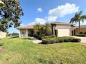 Charming single-story home with a well-manicured lawn, stone accents, and a two-car garage at 650 Portofino Drive, Poinciana, FL 34759