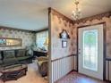 Inviting foyer with decorative wall paper, a leaded glass front door, and chandelier at 724 Knob Hill Cir, Kissimmee, FL 34744