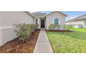 Inviting home exterior with a well-maintained front yard and walkway at 724 Lake Cummings Blvd, Lake Alfred, FL 33850