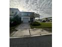 Charming two-story townhome with lush landscaping and a paved driveway at 755 Driving Range Ct, Reunion, FL 34747