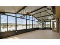 Enclosed lanai with ceiling fans and scenic lake views at 759 Glendora Rd, Poinciana, FL 34759