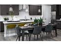 Dining room area featuring a sleek dining table with seating for six adjacent to the kitchen at 1007 Wisteria Way, Dundee, FL 33838