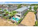 Aerial view of a house with a backyard pool and a spacious fenced in yard at 1021 Castle Pines Ct, Reunion, FL 34747