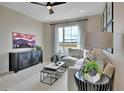 Comfortable living room featuring modern furnishings, a mounted TV, and plenty of natural light at 1026 Wisteria Way, Dundee, FL 33838