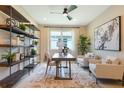Beautiful home office space with large windows and a comfortable seating area at 1034 Wisteria Way, Dundee, FL 33838
