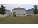 Large back yard with partial fence and view of neighboring homes at 11273 Amber Ridge Dr, Zellwood, FL 32798