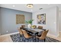 Modern dining room featuring a stylish chandelier, sophisticated wall decor, and a designer rug at 1176 Epson Oaks Way, Orlando, FL 32837