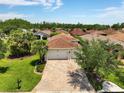 Aerial shot of home featuring lush landscaping and well manicured yard at 1306 Harbor Ridge Dr, Kissimmee, FL 34759