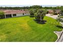 Wide shot of the backyard featuring lush green grass, and a screened lanai at 1306 Harbor Ridge Dr, Kissimmee, FL 34759