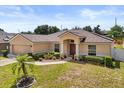 Well-maintained home with landscaped front yard, featuring a front-facing garage and a classic design at 131 Highland Meadows Pl, Davenport, FL 33837