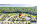Beautiful aerial view of a residential area with lush green trees and a serene lake at 156 Bristol Forest Trl, Sanford, FL 32771