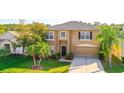 Charming two-story home with a well-manicured lawn, lush landscaping, and a welcoming front entrance at 156 Bristol Forest Trl, Sanford, FL 32771