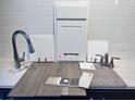 Close-up of design options, featuring cabinets, countertops, flooring, and fixtures against a white subway tile backsplash at 183 Flag Lilly Ln, Umatilla, FL 32784