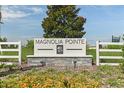 Magnolia Pointe community sign with manicured flowers and landscape providing a welcoming entrance at 187 Flag Lilly Ln, Umatilla, FL 32784