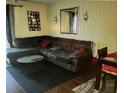 Cozy living room featuring a large sectional sofa, rug, and decorative wall hangings, creating an inviting space at 1948 Lake Atriums Cir # 115, Orlando, FL 32839