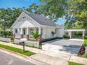 Attractive home boasting a carport, gravel driveway, and a neatly maintained lawn with lush landscaping at 217 W Bay St, Winter Garden, FL 34787