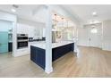 Open kitchen featuring a large island, stainless steel appliances, and a view to the dining area at 217 W Bay St, Winter Garden, FL 34787