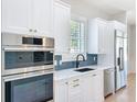 Well-appointed kitchen boasting stainless steel appliances, sleek countertops, and modern fixtures at 217 W Bay St, Winter Garden, FL 34787