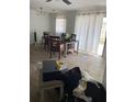 Dining room with seating and natural light through sliding glass doors at 225 Ronnie Cir, Orlando, FL 32811