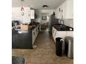 Bright kitchen featuring sleek black countertops and white cabinets at 225 Ronnie Cir, Orlando, FL 32811