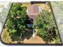 Aerial view of a cozy house with a well-maintained backyard surrounded by trees at 2401 8Th St, St Cloud, FL 34769