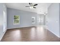 Spacious living room with wood floors, natural light, and a ceiling fan at 2401 8Th St, St Cloud, FL 34769