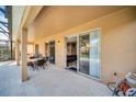 A covered patio offers a relaxing space with sliding doors leading to the home's interior at 2632 Emerald Island Blvd, Kissimmee, FL 34747
