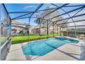 Enjoy the beautiful screened-in pool and spa and your lush green yard with privacy at 2632 Emerald Island Blvd, Kissimmee, FL 34747
