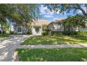 Beautiful home with a well-manicured lawn and mature landscaping, featuring a tile roof at 2746 Kissimmee Bay Cir, Kissimmee, FL 34744