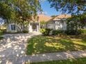 Charming single story home with a well-manicured lawn and mature landscaping, featuring a tile roof at 2746 Kissimmee Bay Cir, Kissimmee, FL 34744