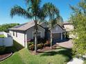 Beautiful home with well-manicured lawn and garden, featuring a three-car garage and brick paved driveway at 2888 Spring Breeze Way, Kissimmee, FL 34744