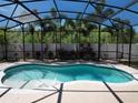 Inviting screened-in pool area offering privacy and a refreshing outdoor oasis at 2888 Spring Breeze Way, Kissimmee, FL 34744