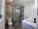 Stylish bathroom with frameless shower, Herringbone tile floor, modern fixtures, and a white vanity at 3045 Plaza Terrace Dr, Orlando, FL 32803