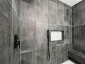 Modern shower with dark gray tile, a built-in niche, matte black fixtures, and a convenient bench at 3045 Plaza Terrace Dr, Orlando, FL 32803
