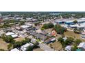 An aerial view showcases a residential neighborhood featuring homes with mature trees and a mix of architectural styles at 31 Cedar St, Haines City, FL 33844