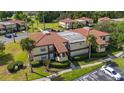 Aerial view of a condo building showing the roof, landscaping, and parking at 3235 Candle Ridge Dr # 102, Orlando, FL 32822