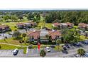 Aerial view of condominium complex showing parking, landscaping, and surrounding area at 3235 Candle Ridge Dr # 102, Orlando, FL 32822