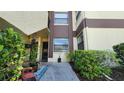 Condo entrance with lush landscaping and a well-maintained walkway at 3235 Candle Ridge Dr # 102, Orlando, FL 32822