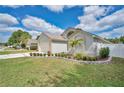 A well-maintained front yard featuring lush green grass, decorative landscaping, and charming curb appeal at 3886 Creek Bed Cir, St Cloud, FL 34769