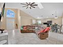 Open concept living room boasts a large arched window, vaulted ceilings, and a comfortable sectional sofa at 3886 Creek Bed Cir, St Cloud, FL 34769