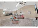 Bright and airy living room with tile floors, vaulted ceilings, and comfortable furnishings at 3886 Creek Bed Cir, St Cloud, FL 34769
